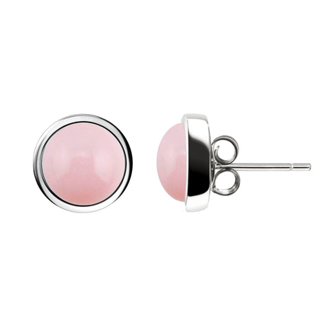 A pair of round stud earrings featuring smooth pink cabochon stones in polished silver bezel settings, shown from front and side angles on a white background.